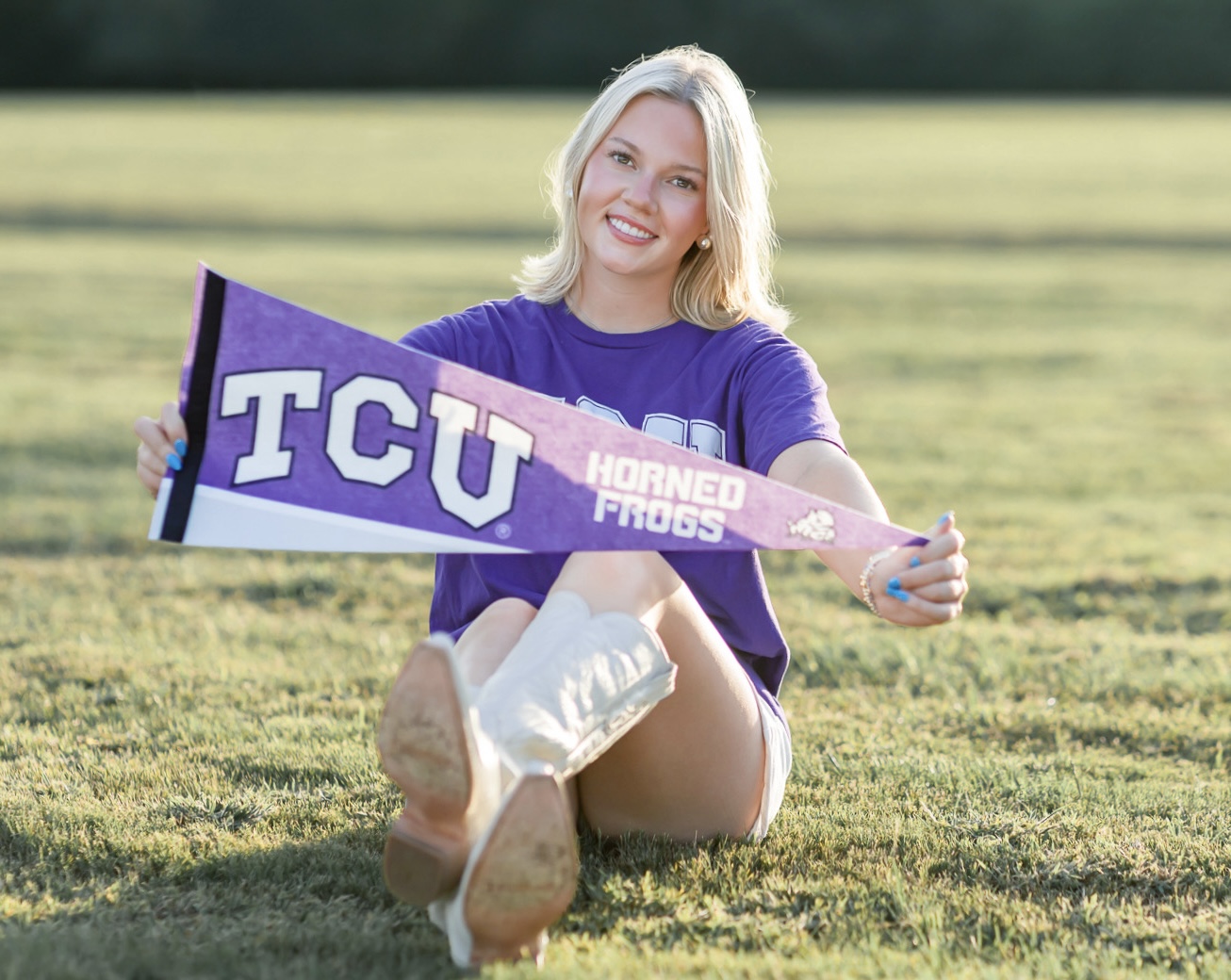 Senior holding a TCU Horned Frogs pennant